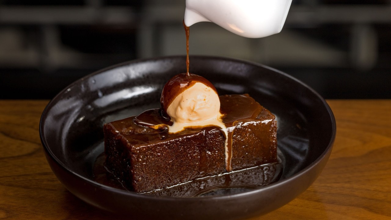 Toffee syrup poured over ice cream and pudding at Bread Street Kitchen