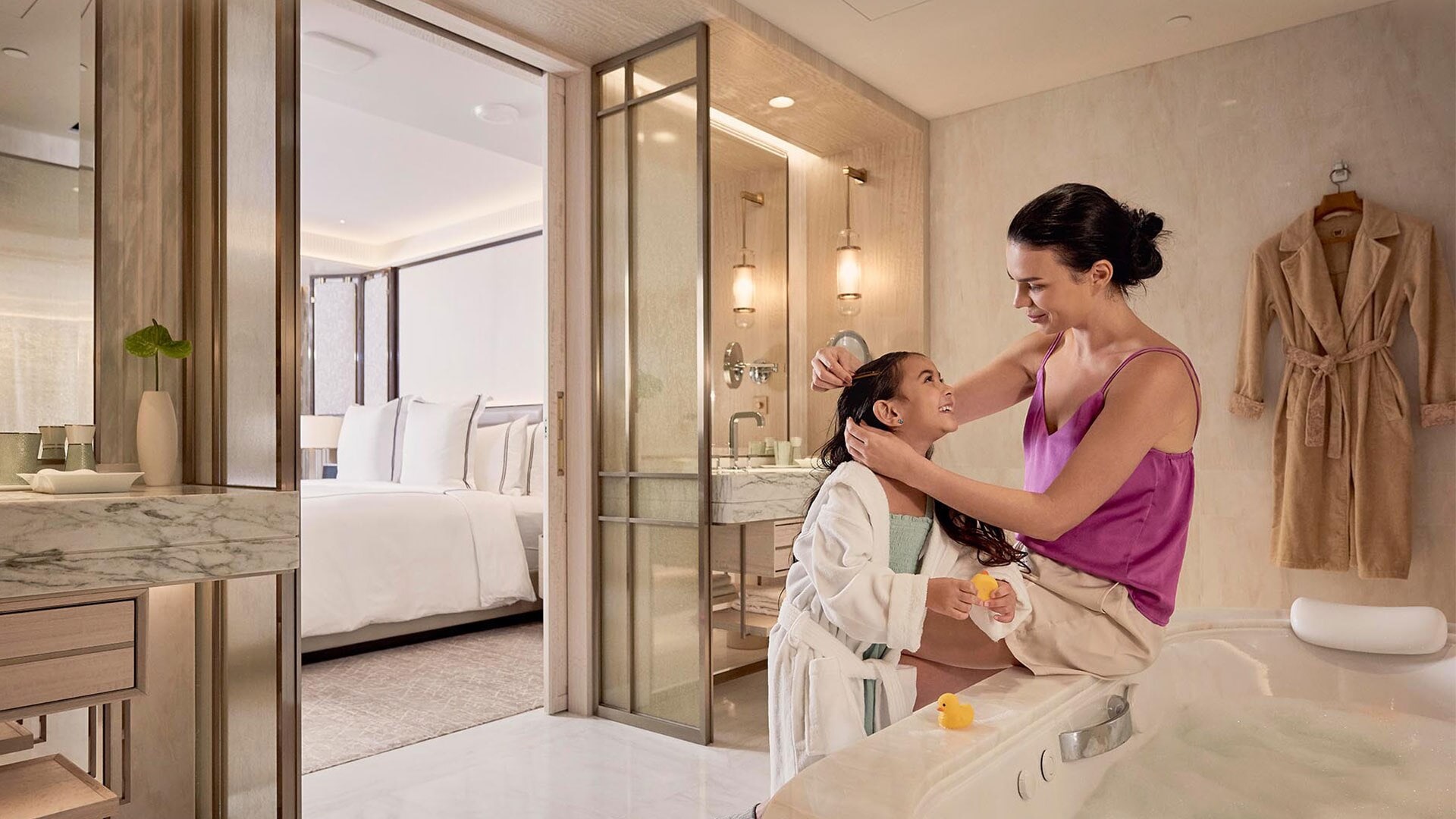 Mother and daughter in the bathroom of the Sands Family Suite, a family room hotel in Singapore