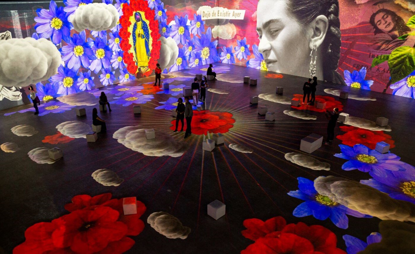 People at an immersive biographical exhibition of Mexican artist, Frida Kahlo