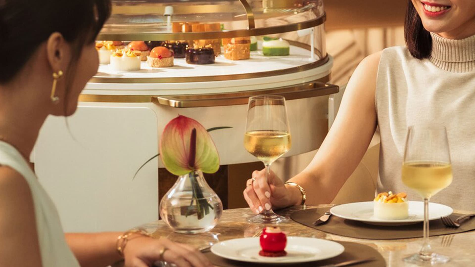 Friends having afternoon tea at The Club, a hotel high tea spot