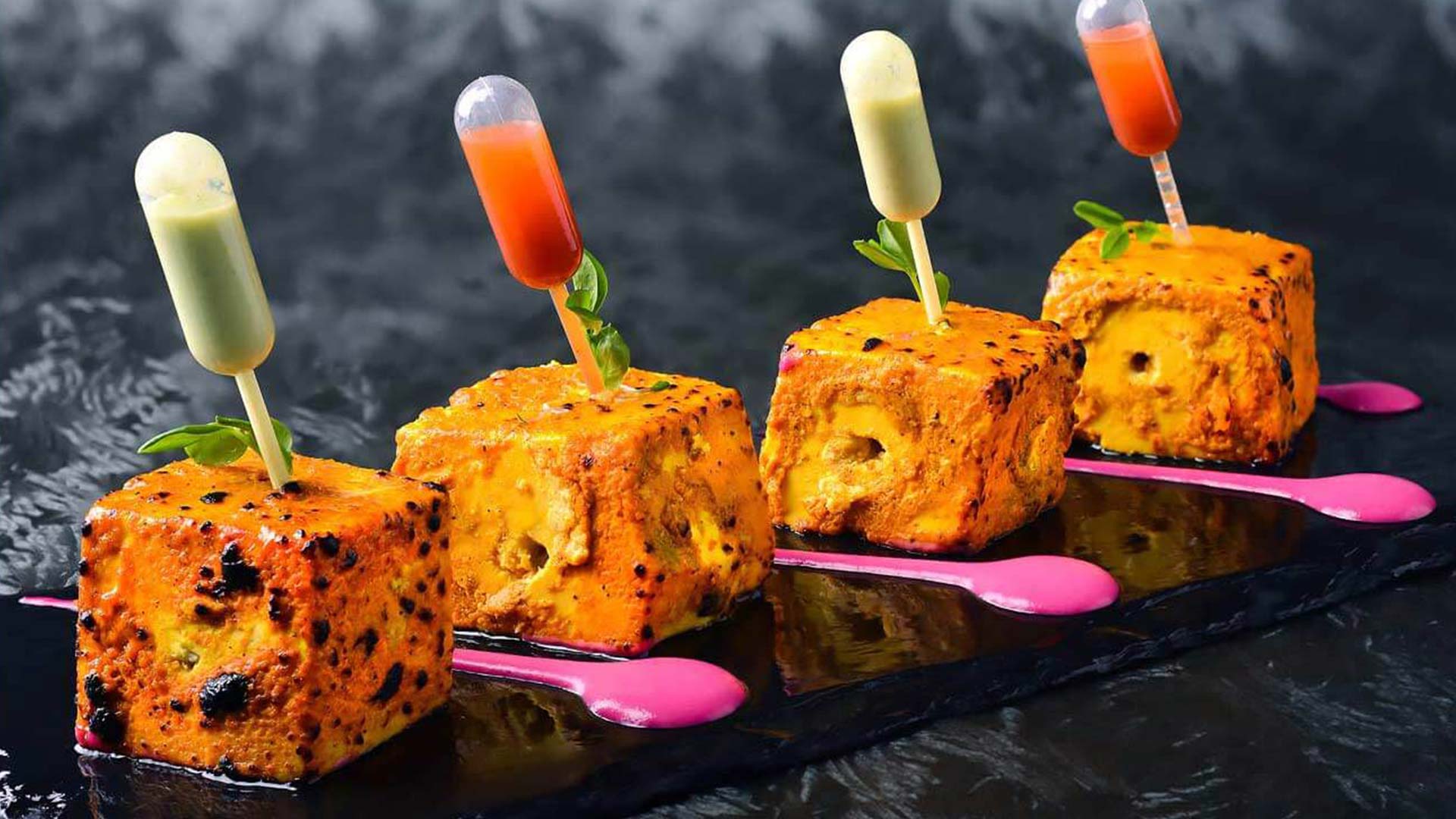 4 cottage cheese with spices and sauces in green and red at Punjab Grill, a vegetarian-friendly restaurant in Singapore