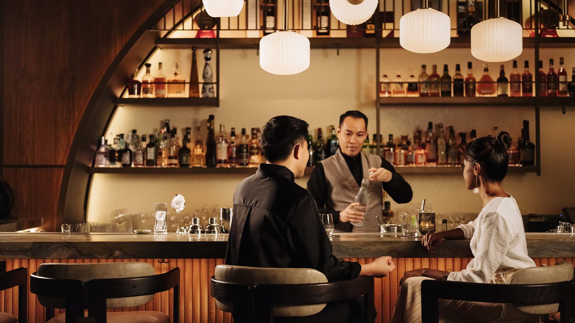 Couple enjoying a crisp glass of beer at Singapore's most coveted beer bars