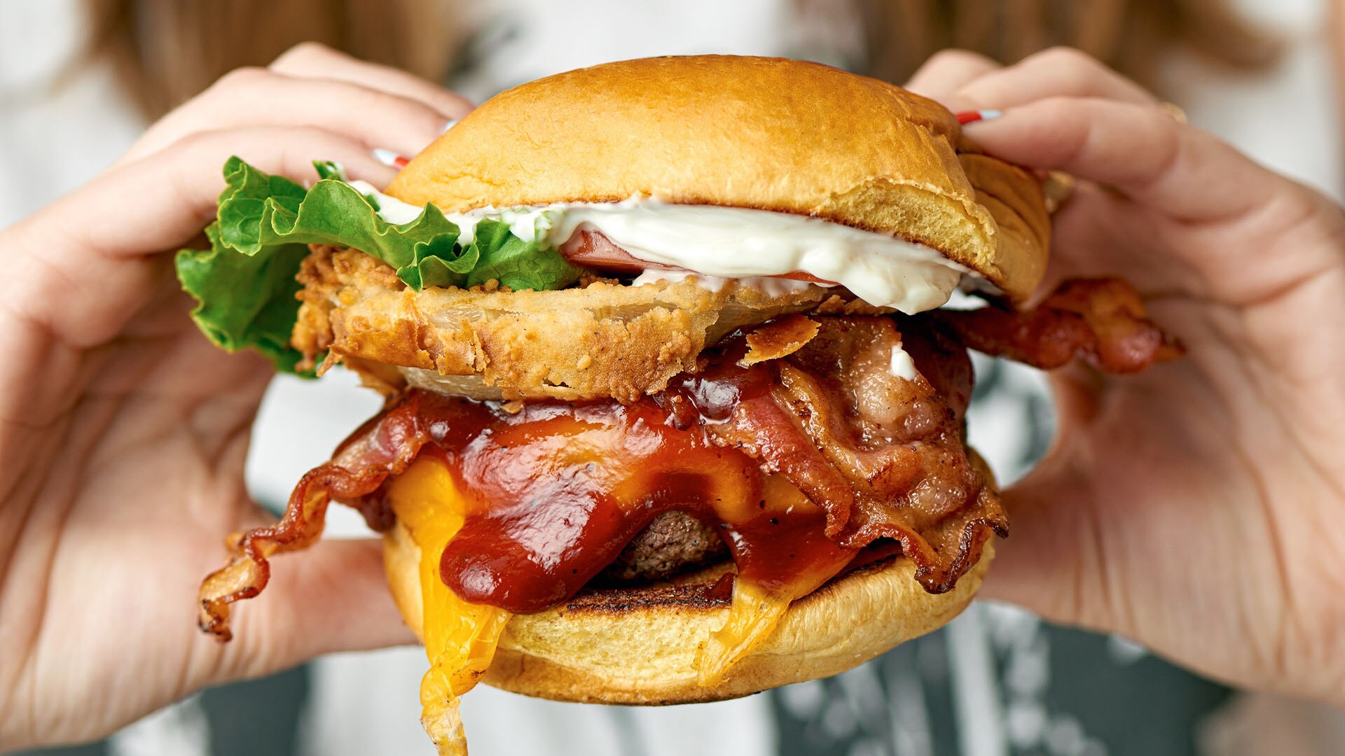 Gourmet stacked burger served at Black Tap, a popular burger spot to celebrate Father's Day 2026