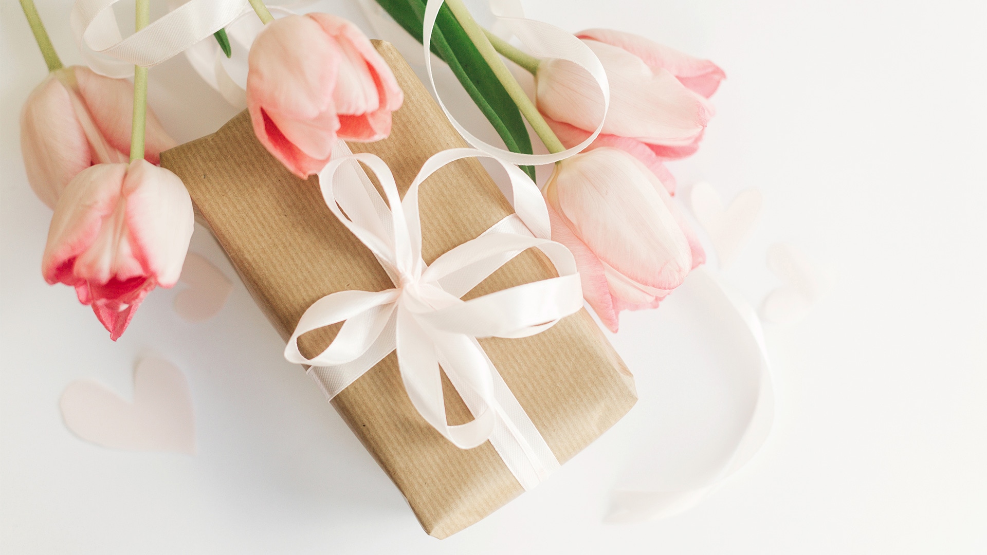 Brown gift box and pink tulips as Mother's Day gifts