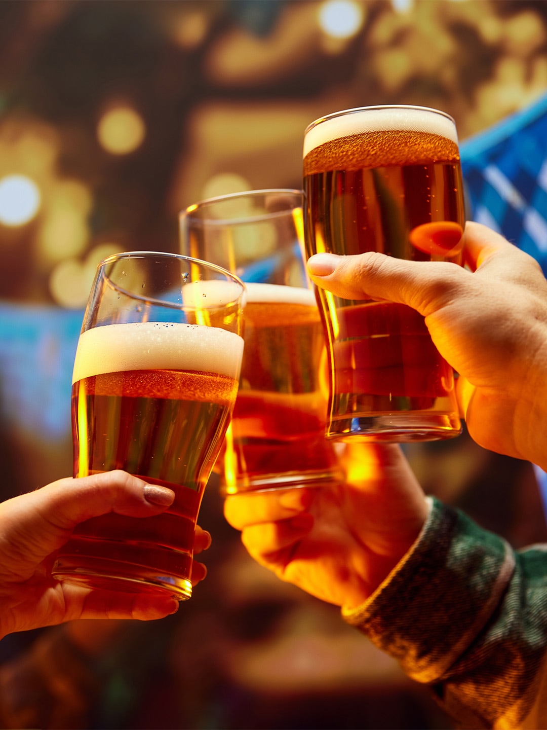 People celebrating Oktoberfest 2025 with a cup of German beer in hand