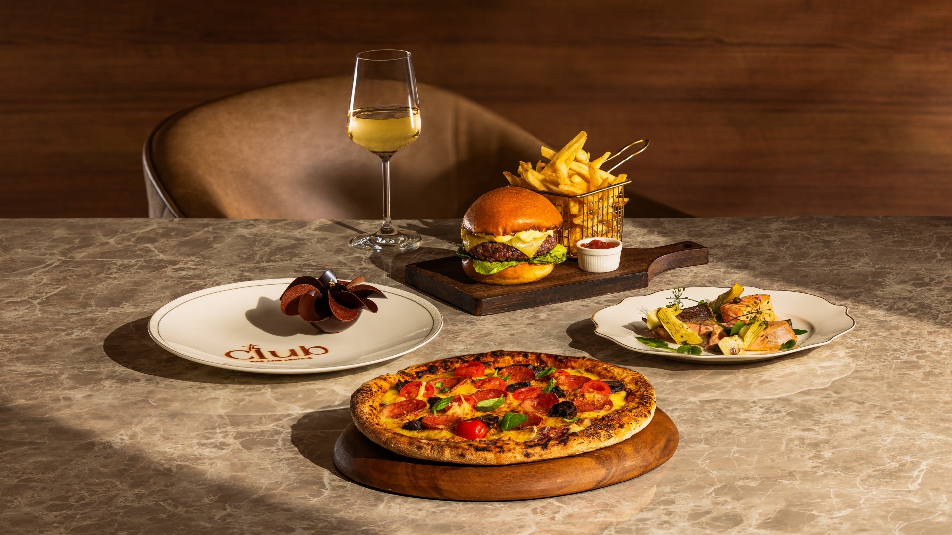 Pizza, burger and a glass of white wine to feast on at The Club, a casual dining spot at Marina Bay Sands