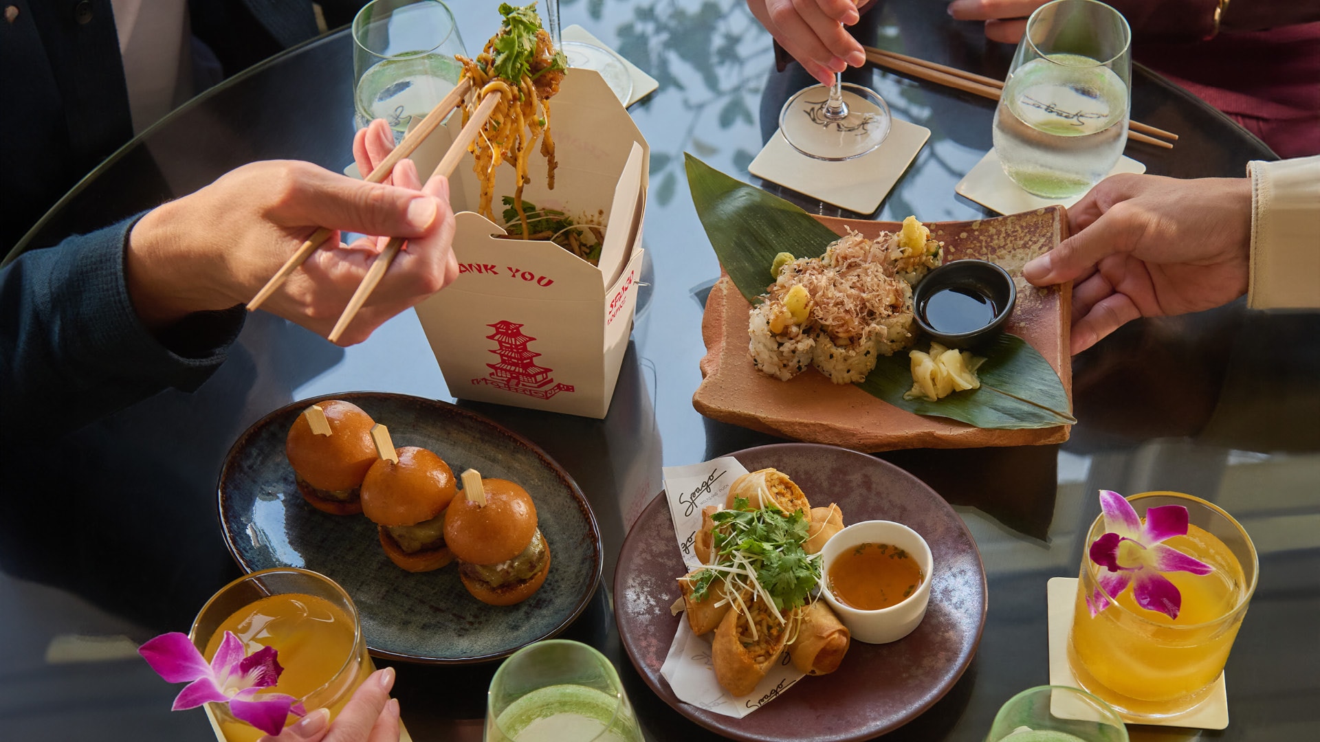 Sharing bites and beef sliders for a casual dining session with friends at Spago Bar & Lounge