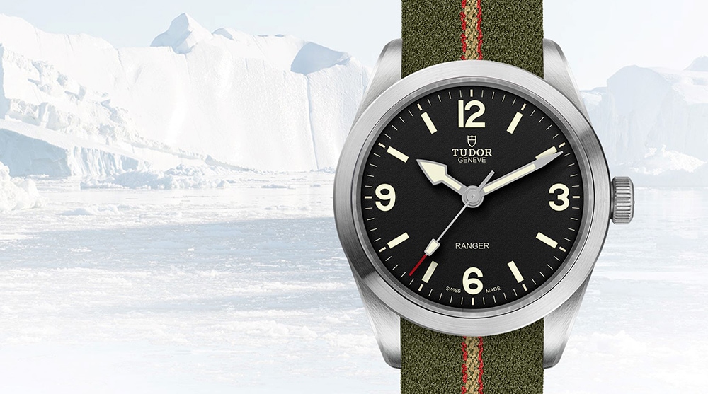 A classic timepiece by luxury watch brand, Tudor with army green strip and black watch face against an iceberg background