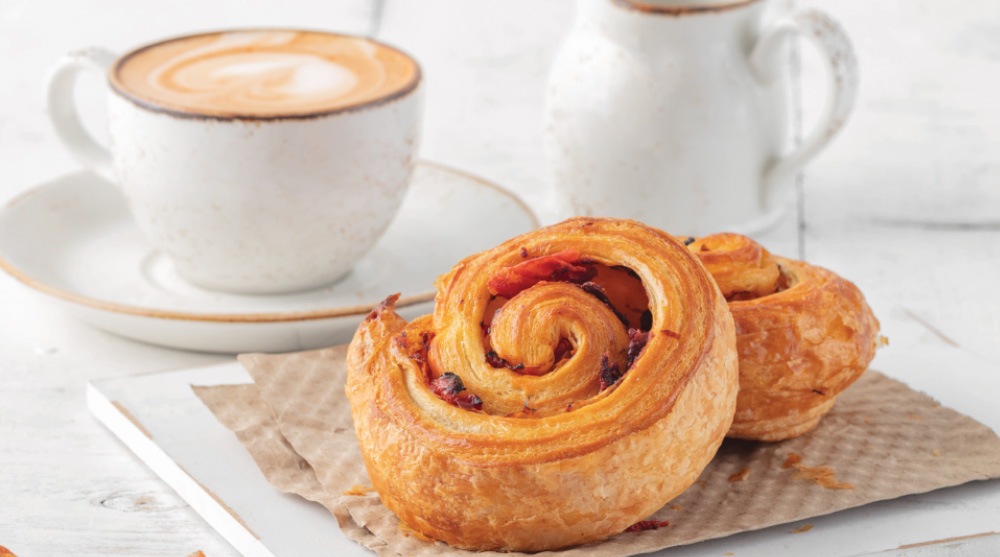 Pastries with a cup of coffee brewed by baristas at SweetSpot, a cafe in Singapore