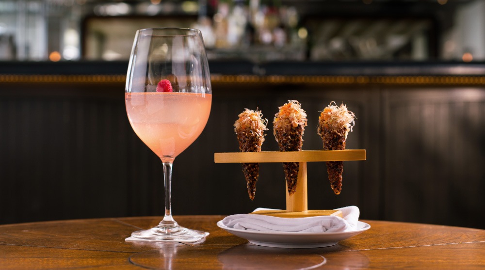 A pink cocktail with three tartare cones served at an instagrammable restaurant, Spago Dining Room
