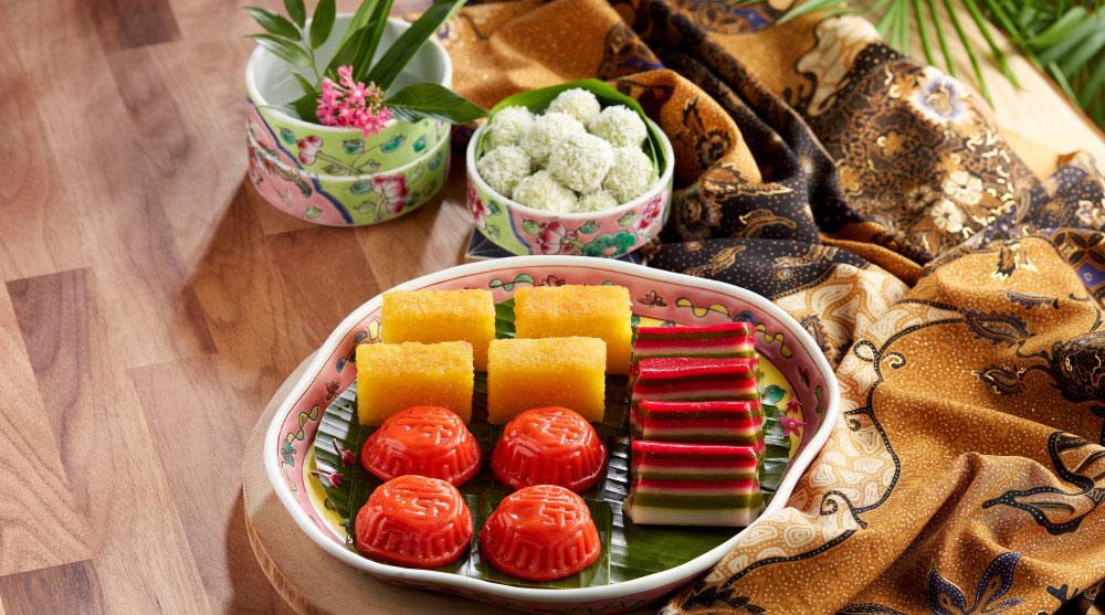 Vegetarian-friendly and colorful Asian kueh plated on banana leaves and batik handkerchief at RISE Restaurant, Marina Bay Sands