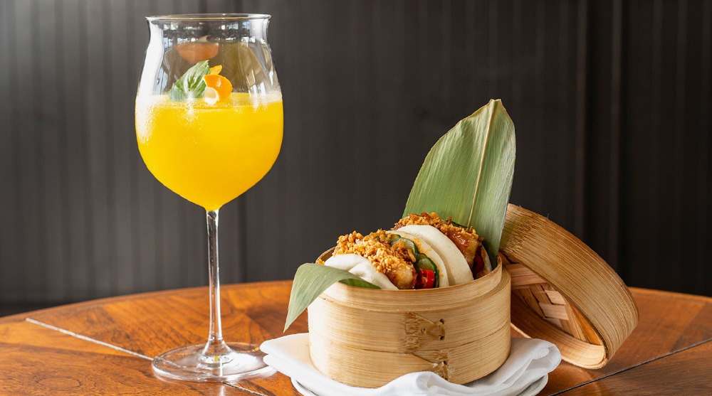 Yellow cocktail and Chinese bun at the best bars in Singapore, Spago Bar & Lounge