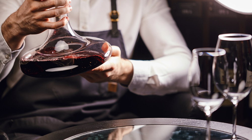 Sommelier holding wine decanter at a wine restaurant in Singapore