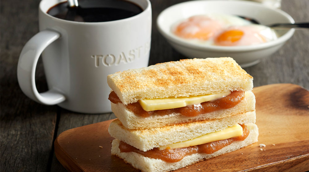 Kaya toast with butter, soft boiled eggs and traditional Singapore coffee, kopi, at Toast Box, which serves local breakfast set
