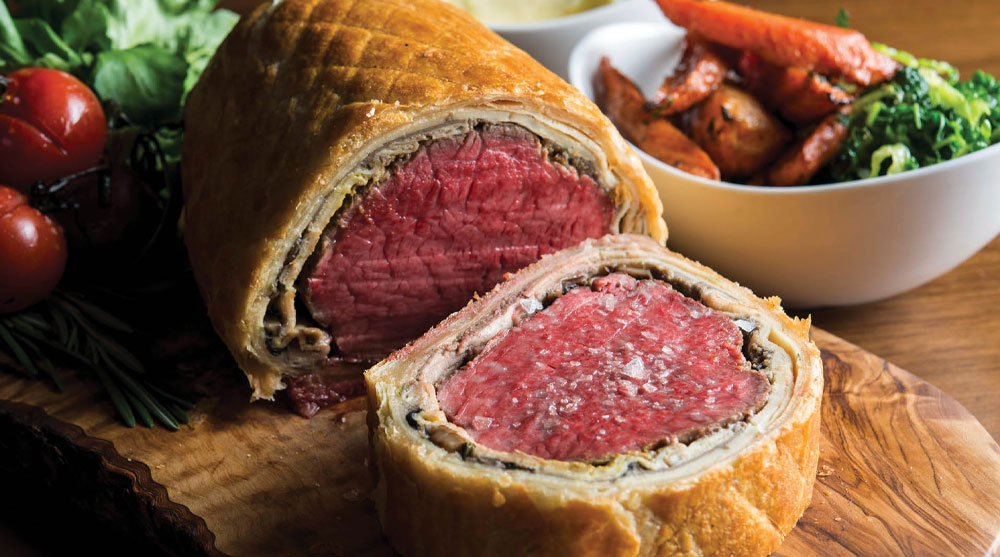 Closeup of Beef Wellington, a medium rare beef wrapped in a puff pastry which is served at Bread Street Kitchen