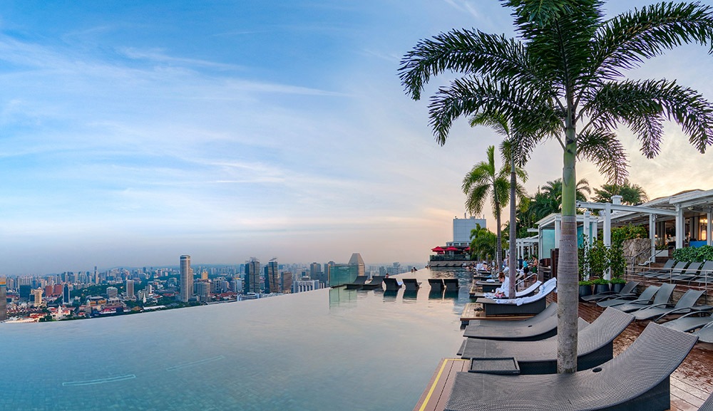 The iconic Infinity Pool at Marina Bay Sands, Singapore with rows of sun lounger in black