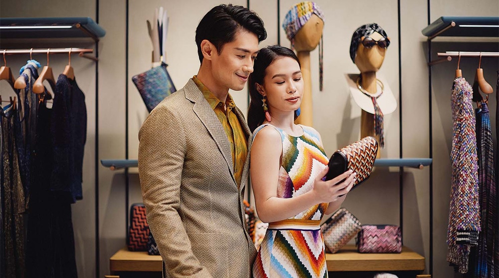 Couple looking at a bag and shopping at a fashion store which sells clothes and accessories at The Shoppes, Marina Bay Sands