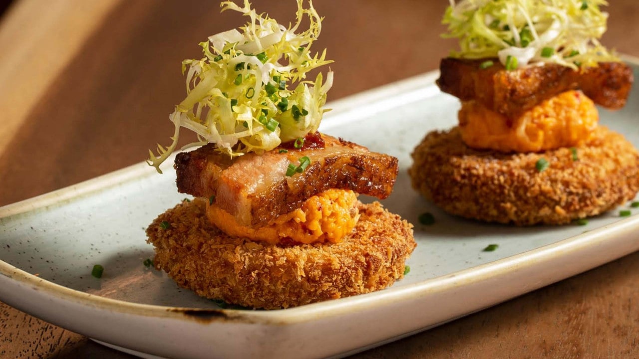 Fried dish topped with pork belly at Yardbird, a waterfront restaurant overlooking the Merlion