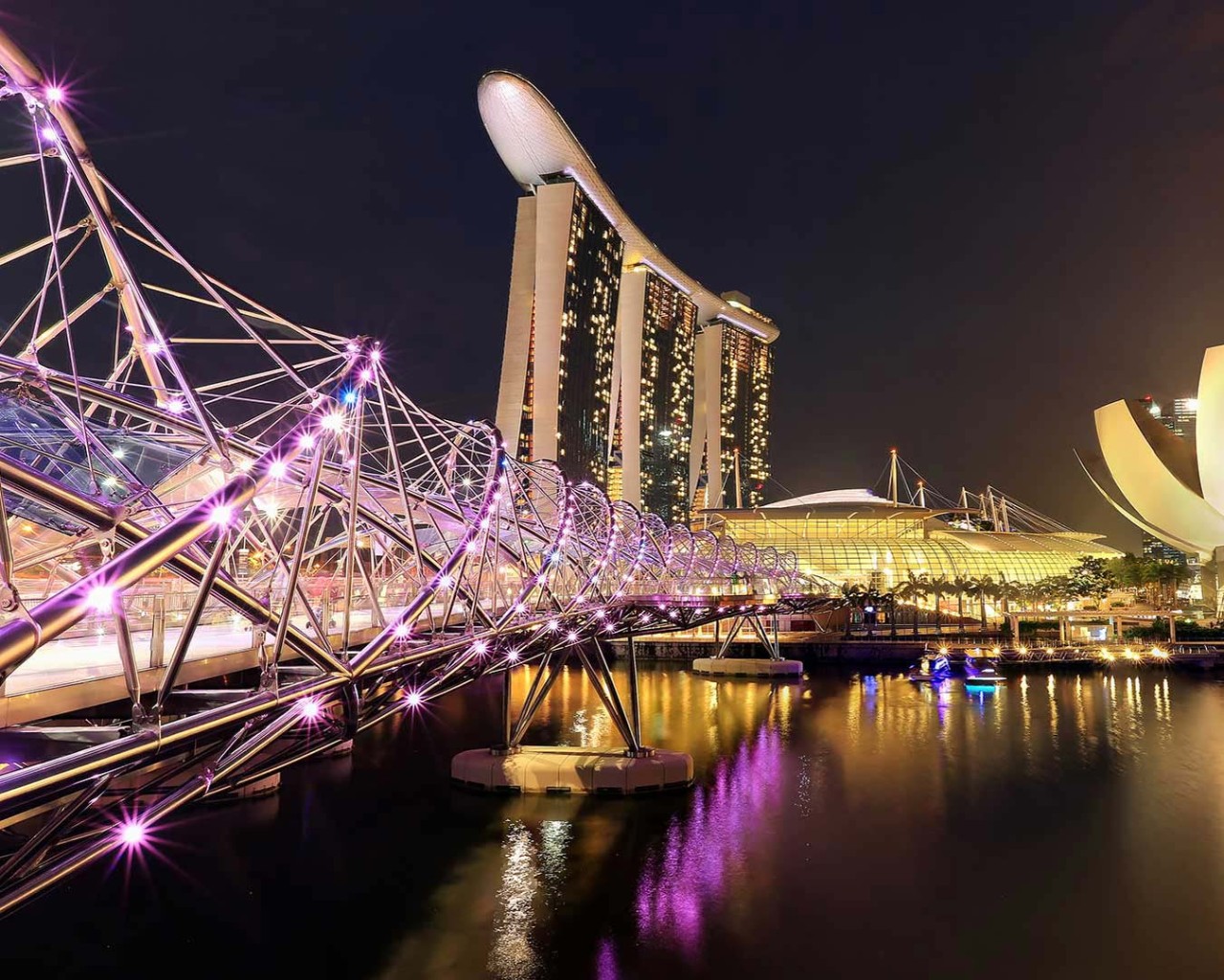 Night view in Singapore along the Helix Bridge with Marina Bay Sands as the backdrop