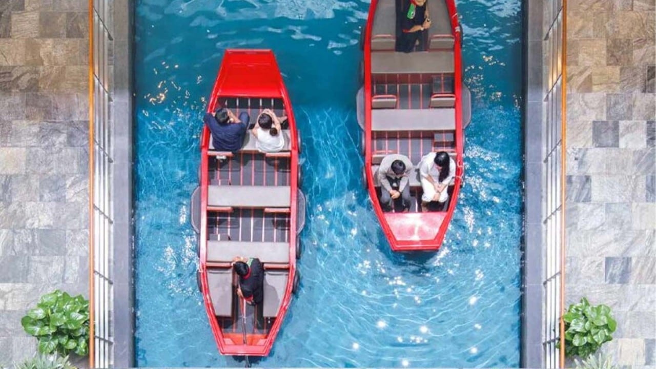 Top view of people in a Sampan Ride, taking photos in Singapore, at Marina Bay Sands