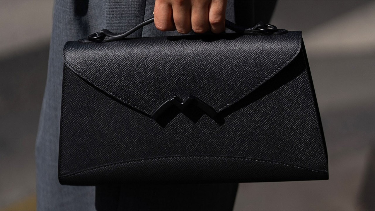Luxury crossbody bag resembling a trunk with the Moynat monogram