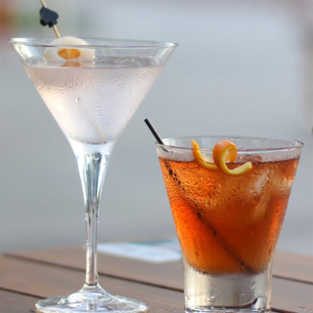 2 cocktails with lychee and orange peel, served at the best bars in Singapore