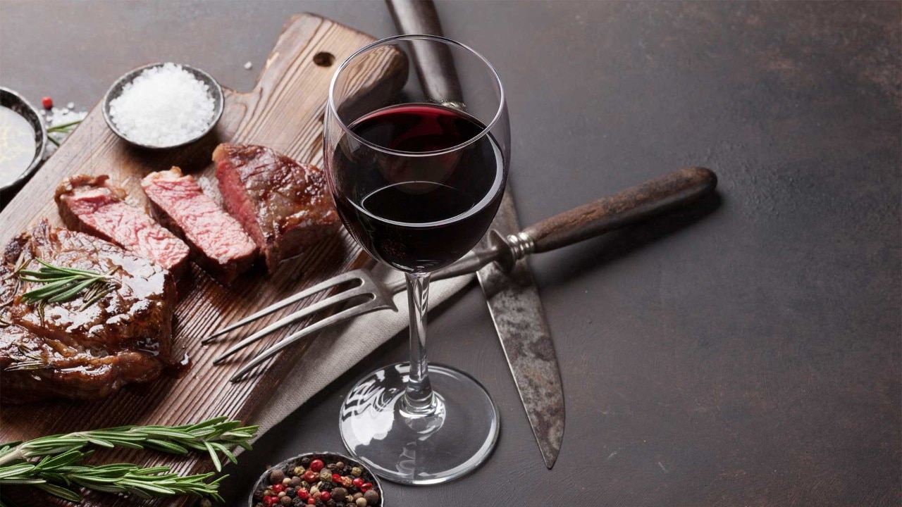 Red wine and grilled ribeye steak to enjoy at the best wine bars in Singapore