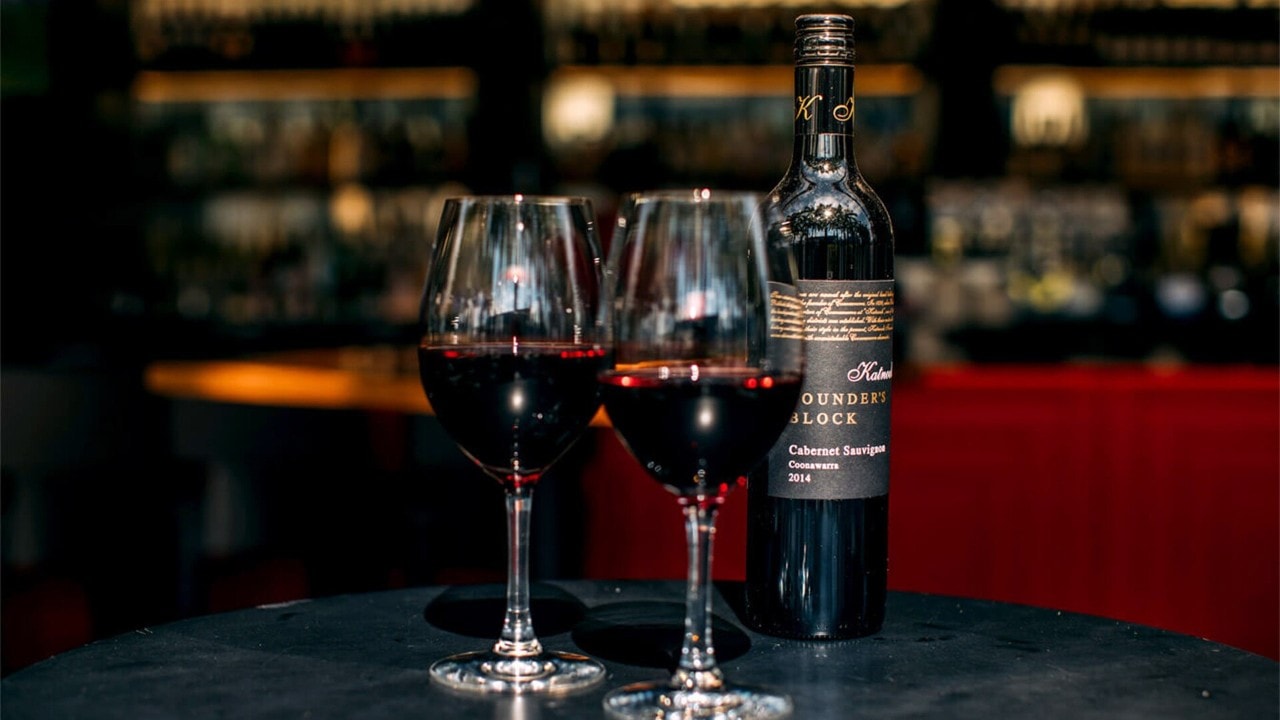 Two glasses and a bottle of red wine at the best wine bar and restaurant in Singapore