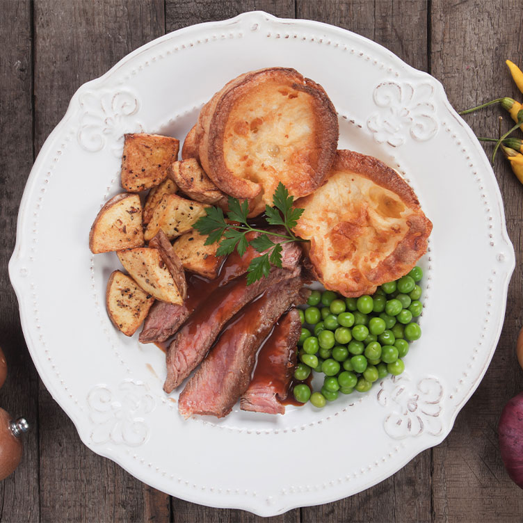 Roast meat, green peas, Yorkshire pudding and potato served at the best Sunday roast places in Singapore