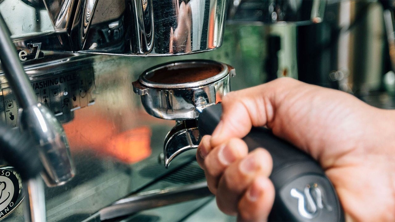Barista preparing a cup of coffee at Origin + Bloom, one of the best coffee cafes at Marina Bay Sands, Singapore