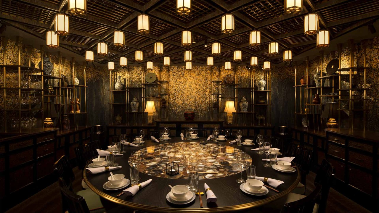 Dining area with wine glass and cutleries lined out at Mott 32, a fine dining vegetarian restaurant in Singapore