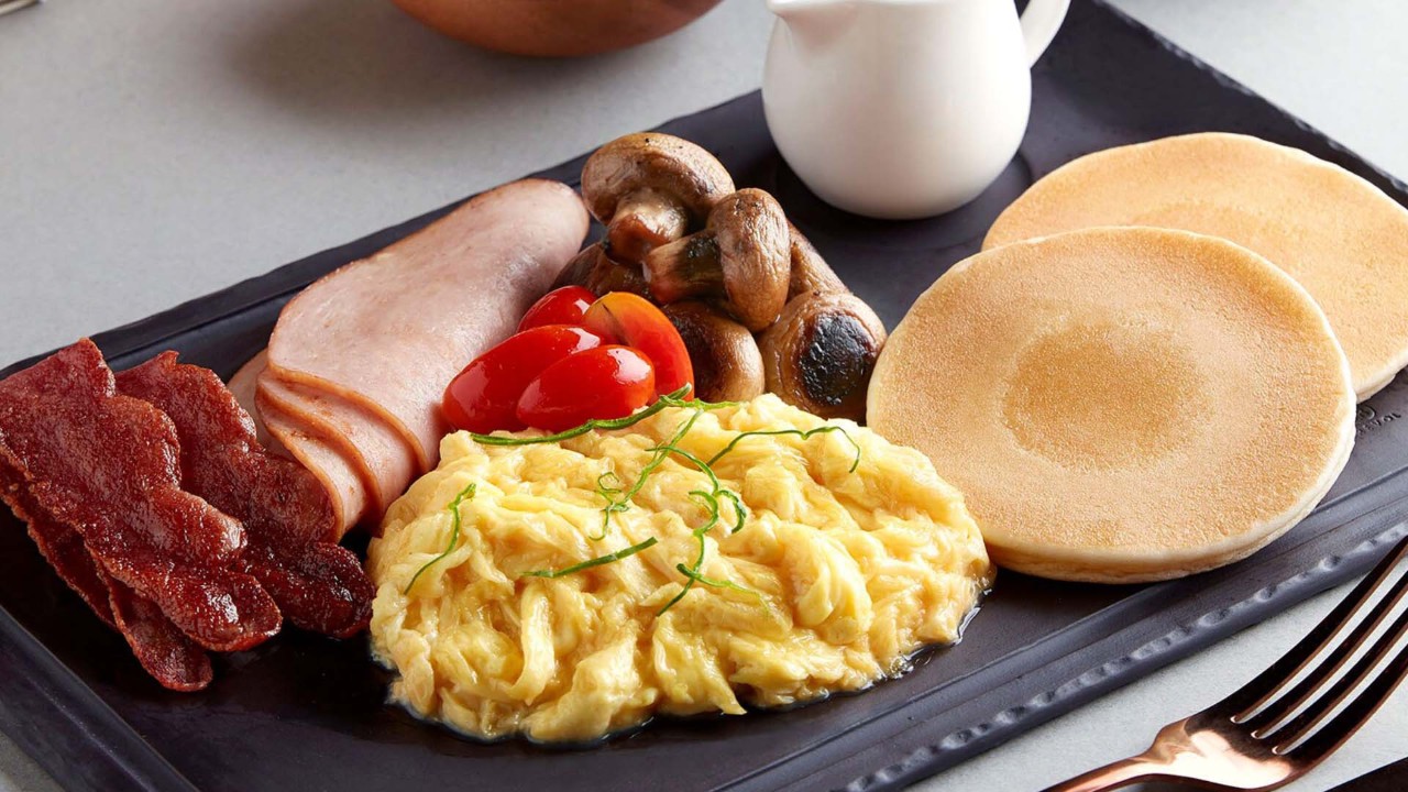 Breakfast platter at the best brunch spots in Singapore, with pancakes and scrambled eggs