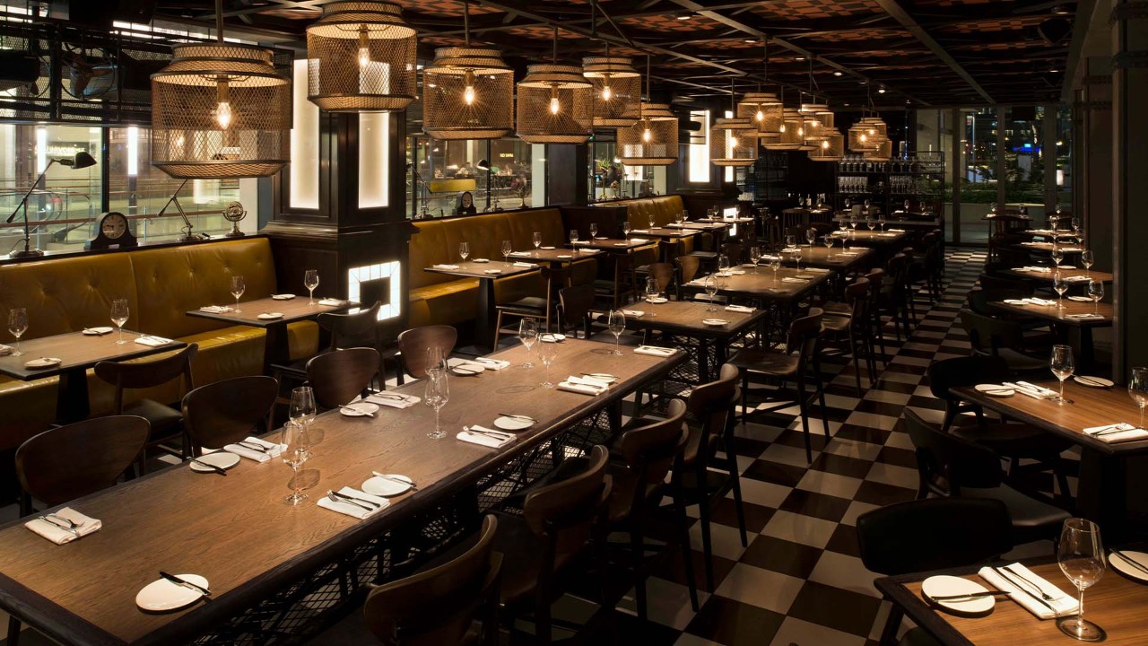 Main dining room in the evening at Bread Street Kitchen, one of the best places for dinner in Singapore