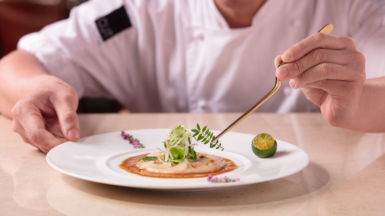 Chef at a fine dining restaurant plating food