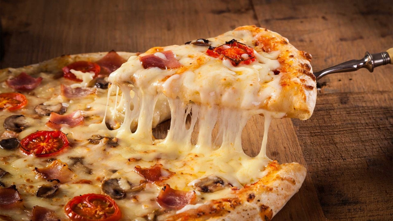 Pizza slice with melted cheese, a famous Italian dish