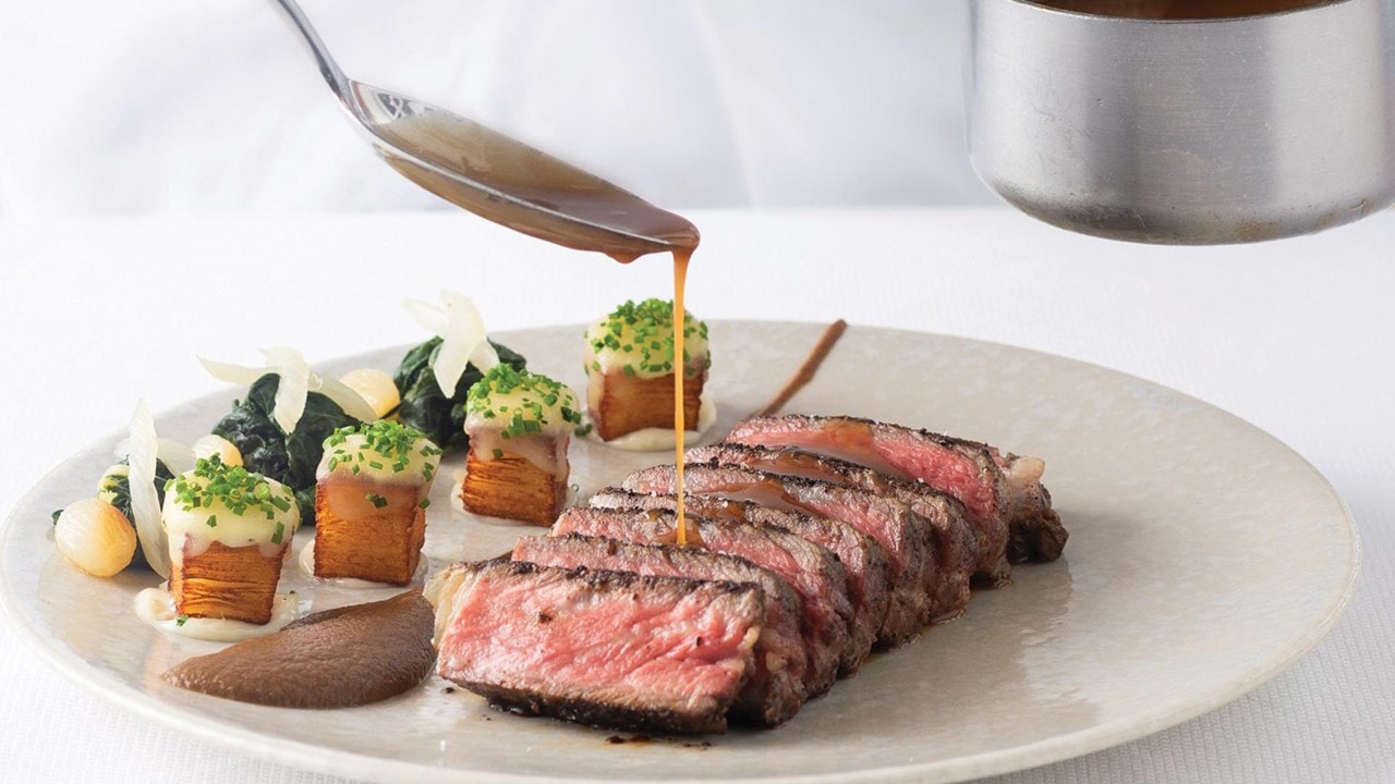 Sauce over prime steak for a formal business lunch at Spago, Singapore