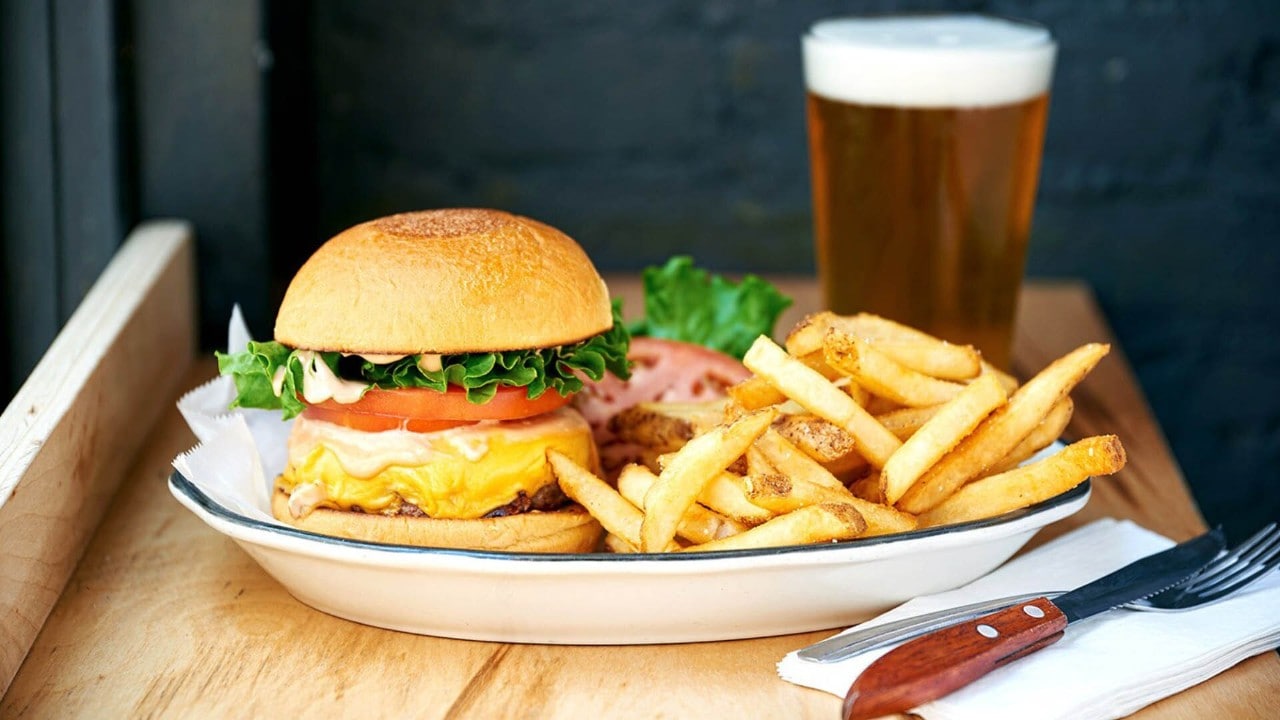 Gourmet burger with a mug of beer for afterwork drinks and gathering