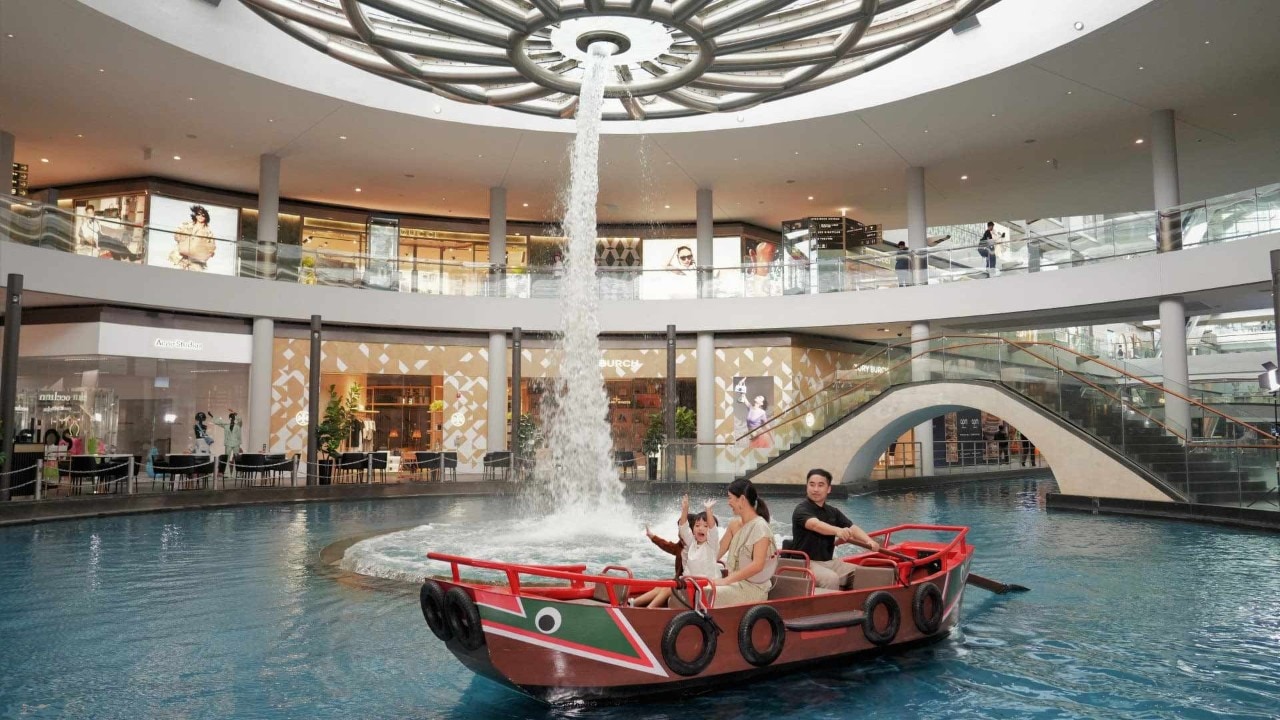Family of three taking a Sampan ride as a Mother's Day activity in Singapore
