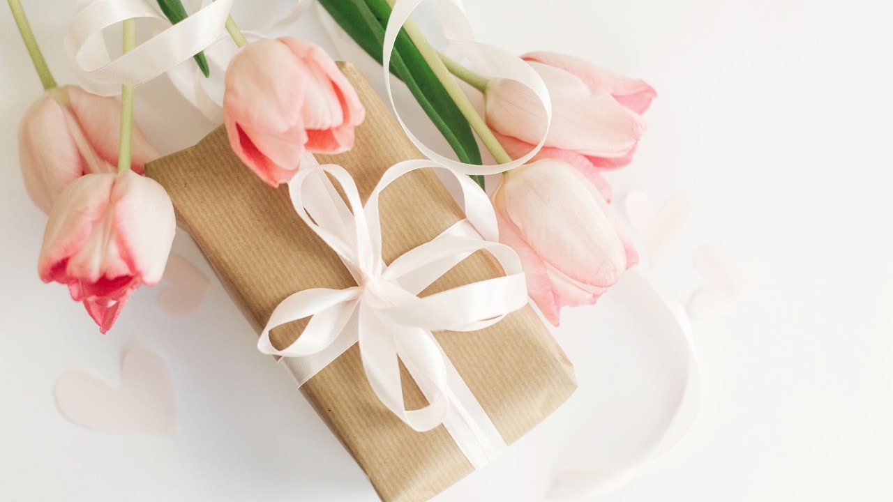 Tulips and present wrapped as gifts for mum on Mother's Day